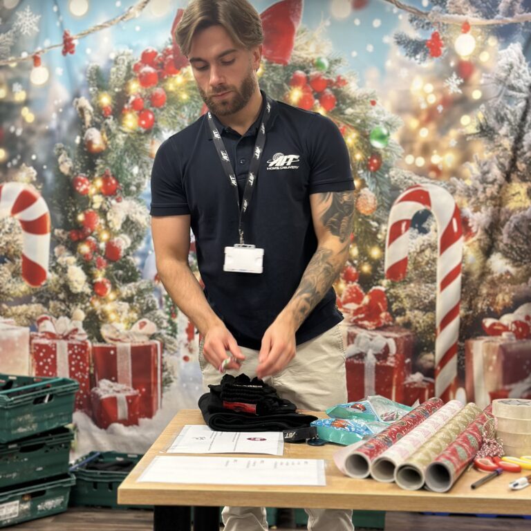 The AIT Home Delivery team wrapping gifts for the Hope Centre